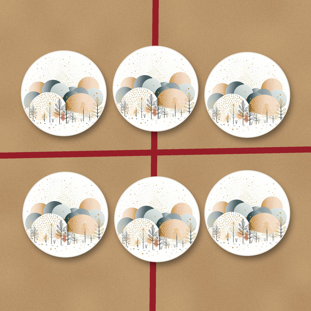 Minimalist Gold Winter Trees round ceramic coasters on kraft gift wrap