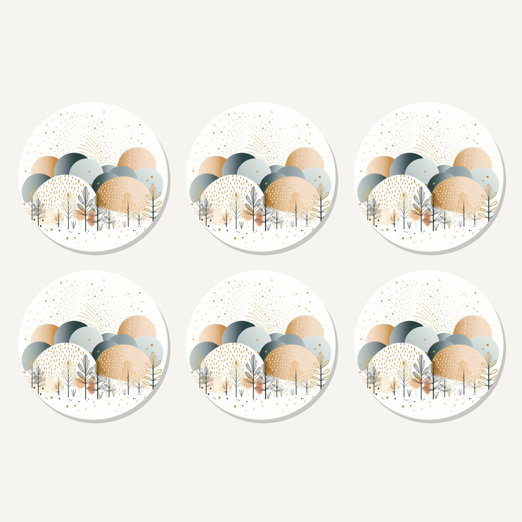Flat lay of the minimalist gold winter trees artwork on six round coasters