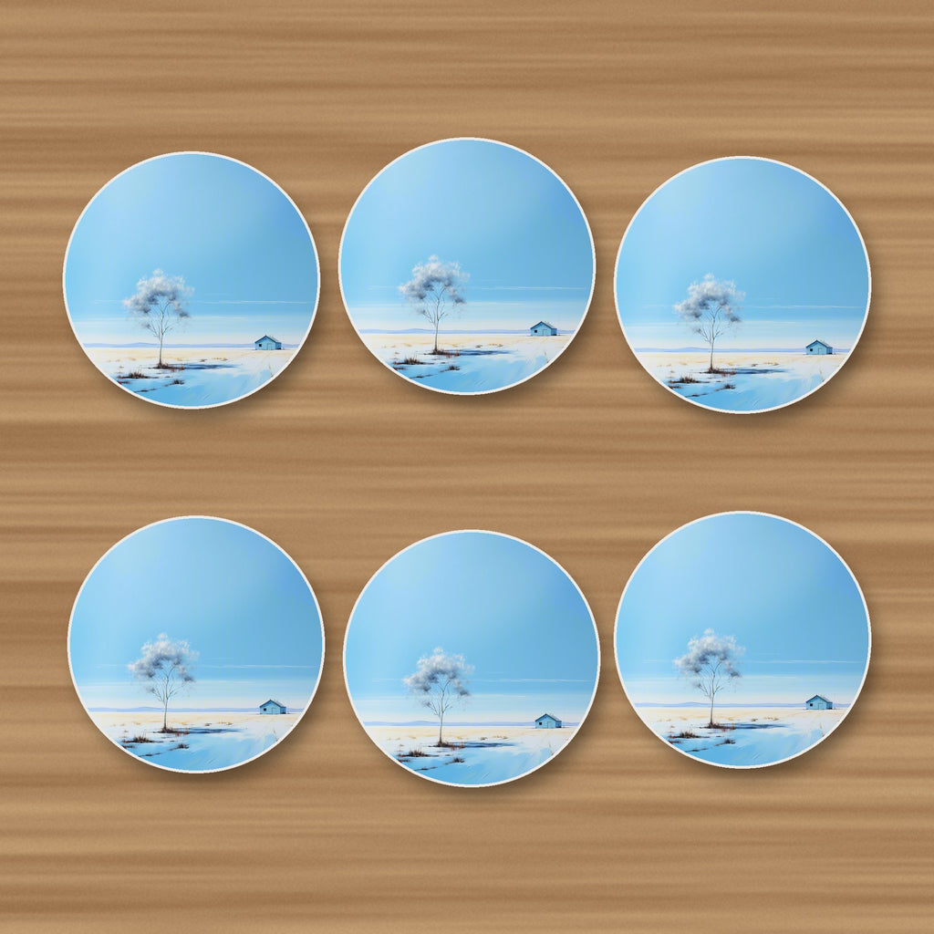 Lone Tree in a Snowy Field round ceramic coasters, set of 6, on an oak coffee table