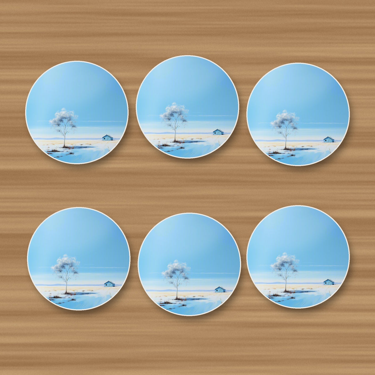 Lone Tree in a Snowy Field round ceramic coasters, set of 6, on an oak coffee table
