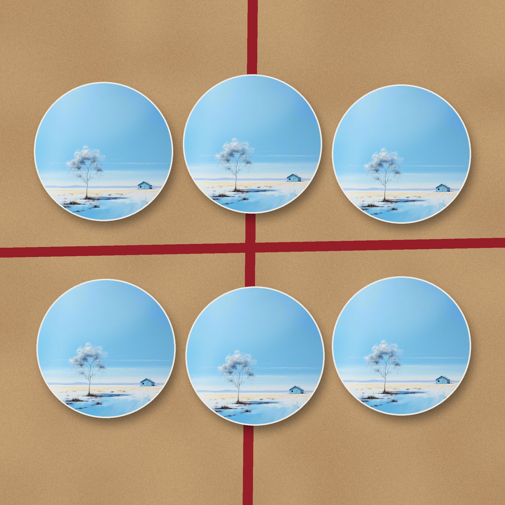 Lone Tree in a Snowy Field round ceramic coasters on kraft gift wrap
