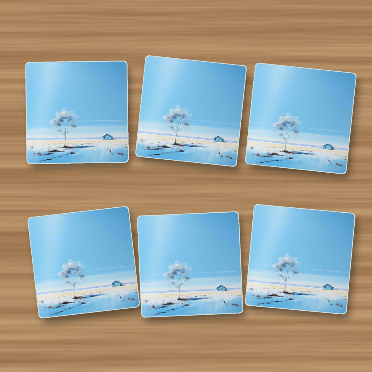 Lone Tree in a Snowy Field square glass coasters, set of 6, on an oak coffee table