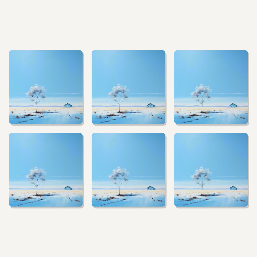 Flat lay of the lone tree in a snowy field artwork on six square coasters