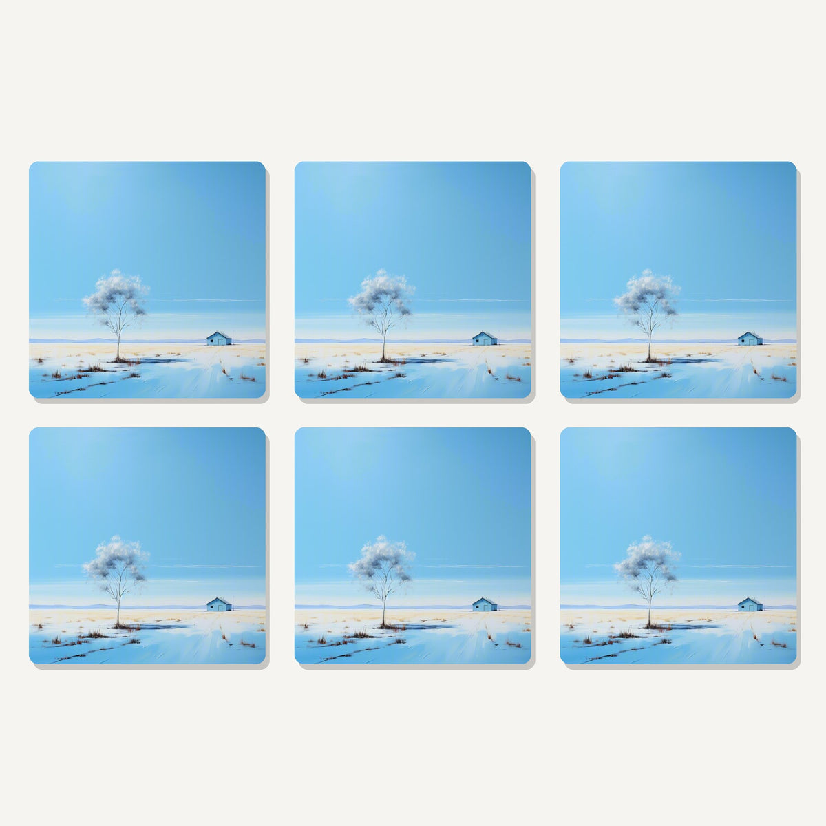 Flat lay of the lone tree in a snowy field artwork on six square coasters