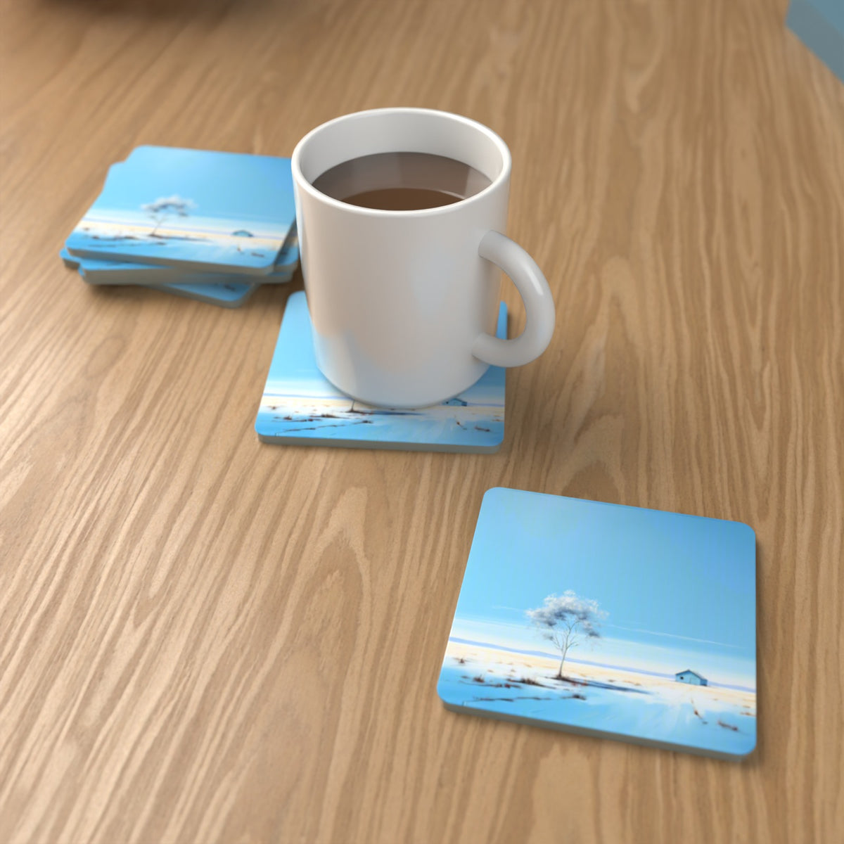 Lone Tree in a Snowy Field Square Glass Coasters – Set of 6 – lifestyle mockup with a mug of coffee