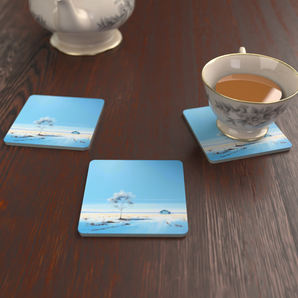 Lone Tree in a Snowy Field Square Glass Coasters – Set of 6 – lifestyle mockup with a teacup