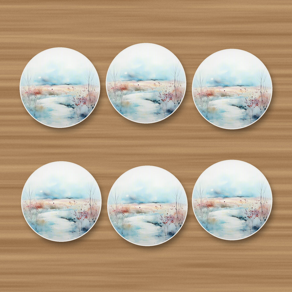 Watercolour Winter Riverbank round ceramic coasters, set of 6, on an oak coffee table