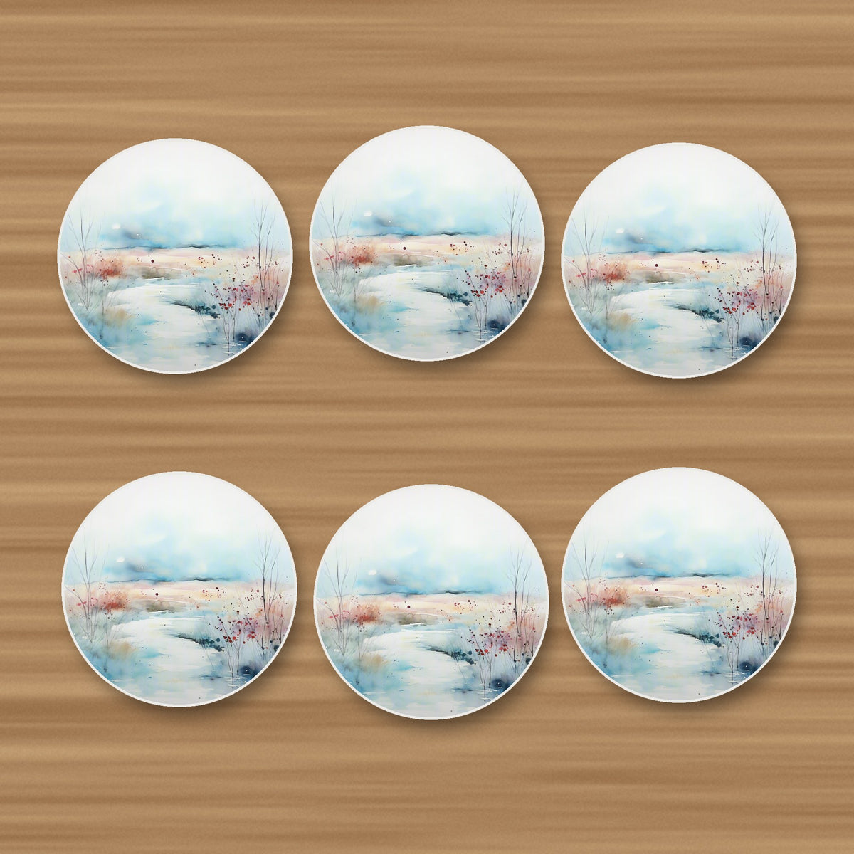 Watercolour Winter Riverbank round ceramic coasters, set of 6, on an oak coffee table