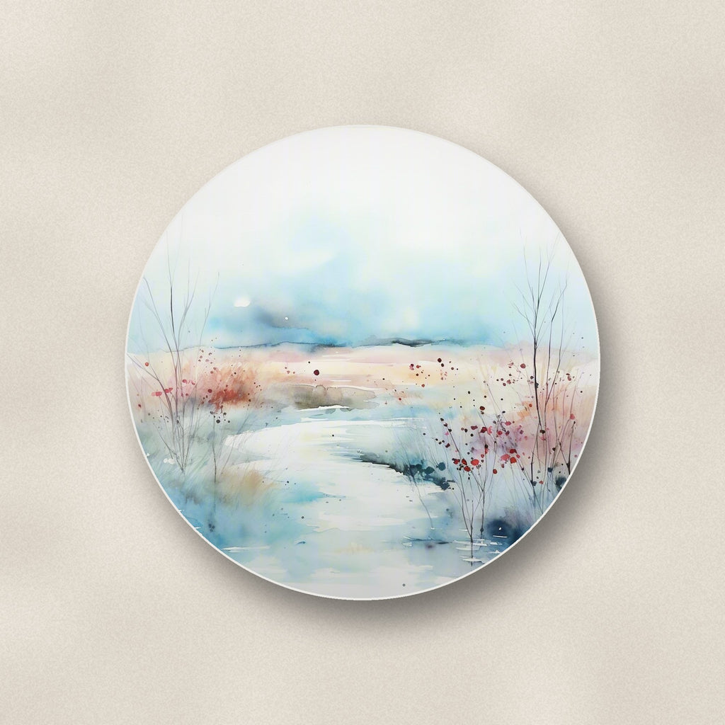 Close-up of one watercolour winter riverbank round ceramic coaster, flat UV print
