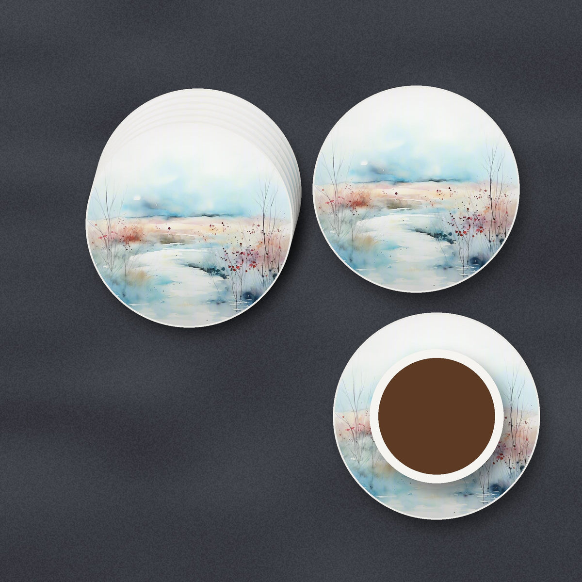 Watercolour Winter Riverbank round ceramic coasters stacked on a slate kitchen worktop