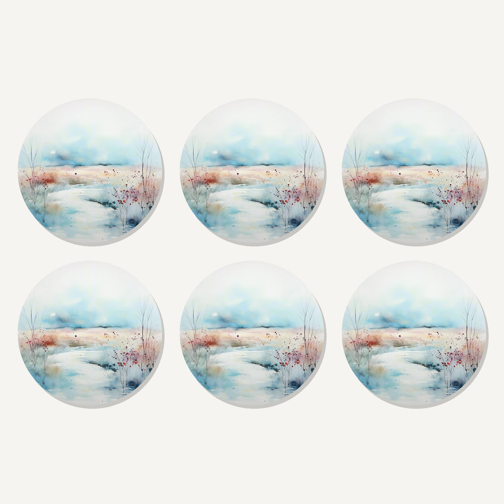 Flat lay of the watercolour winter riverbank artwork on six round coasters