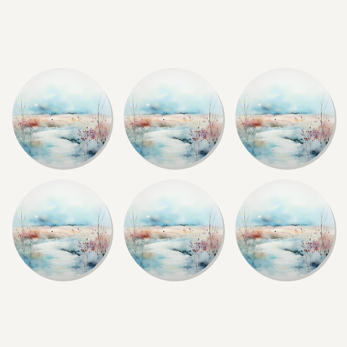 Flat lay of the watercolour winter riverbank artwork on six round coasters