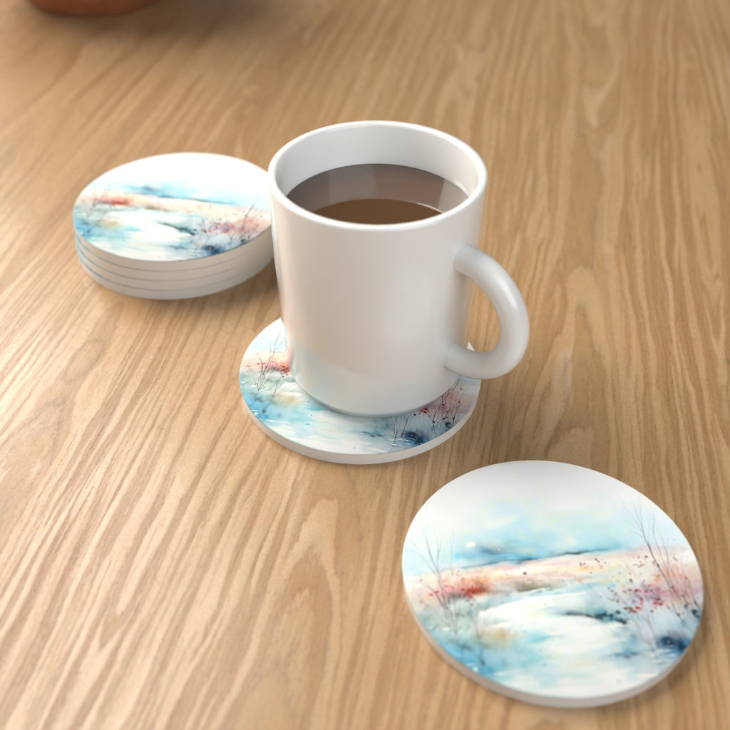 Watercolour Winter Riverbank Round Ceramic Coasters – Set of 6 – lifestyle mockup with a mug of coffee