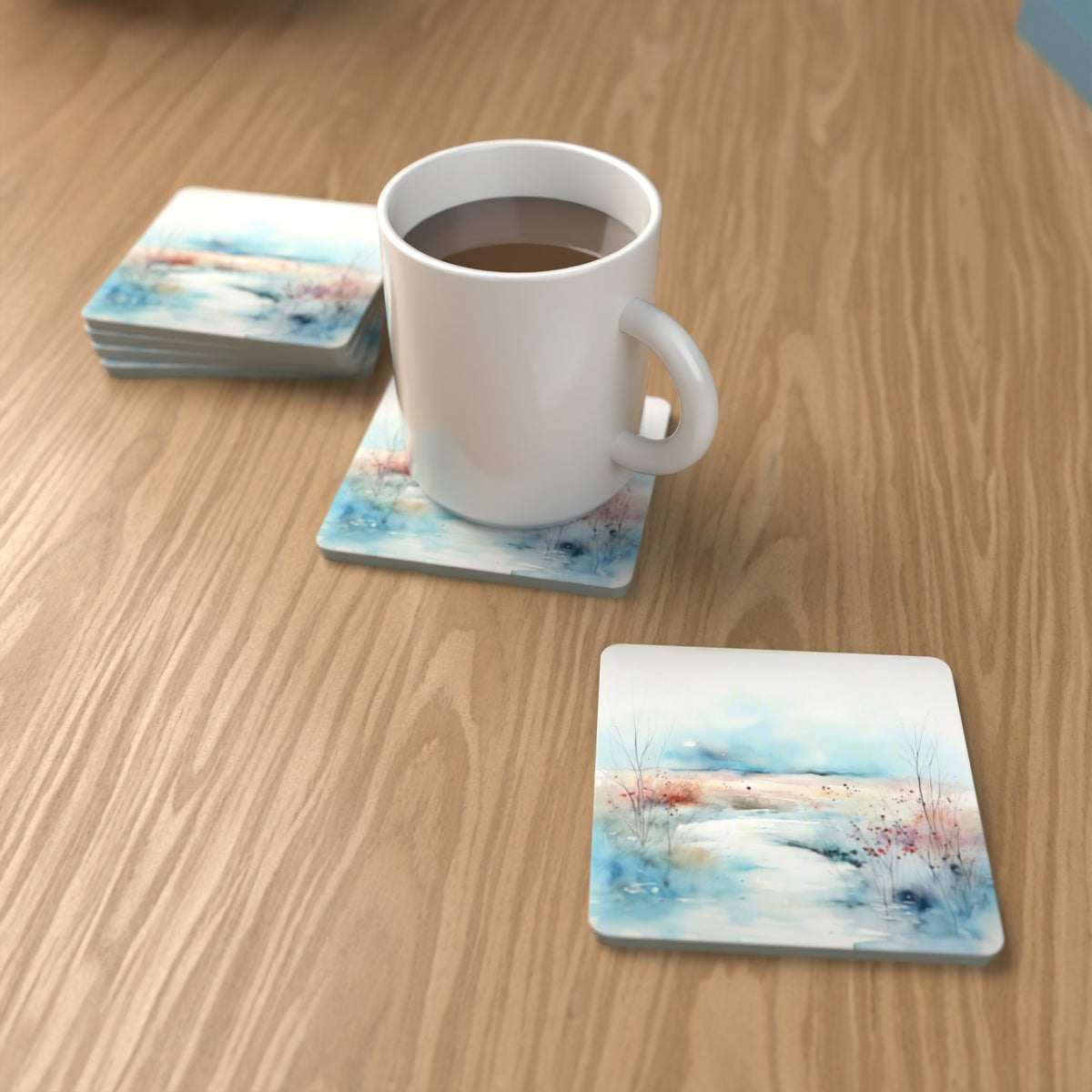 Watercolour Winter Riverbank Square Glass Coasters – Set of 6 – lifestyle mockup with a mug of coffee