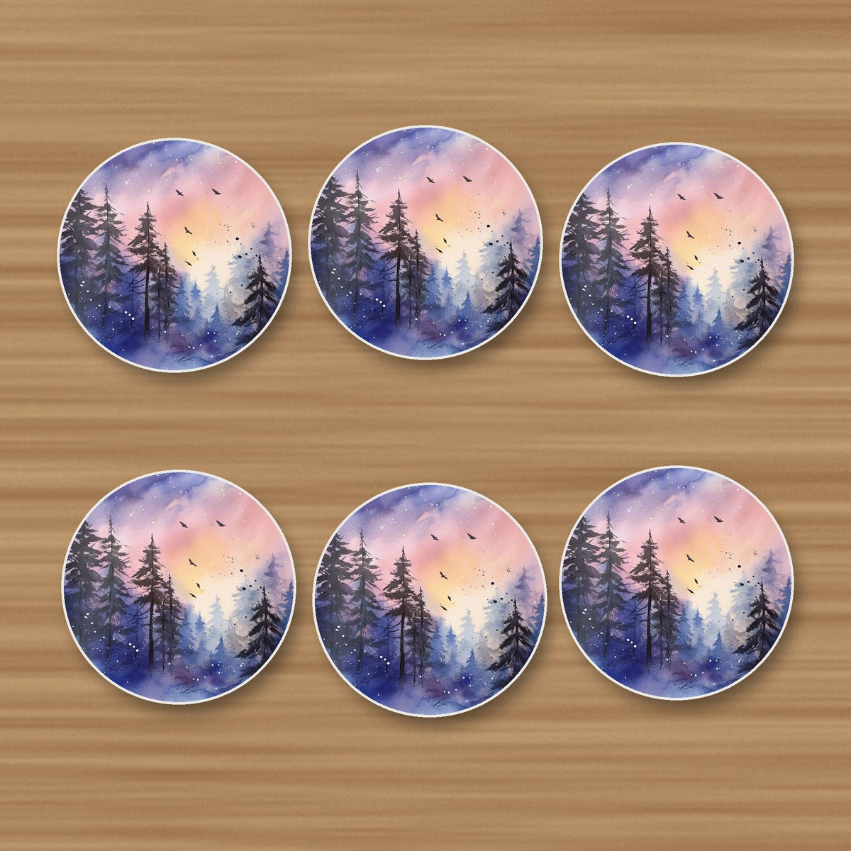 Watercolour Winter Pine Forest round ceramic coasters, set of 6, on an oak coffee table