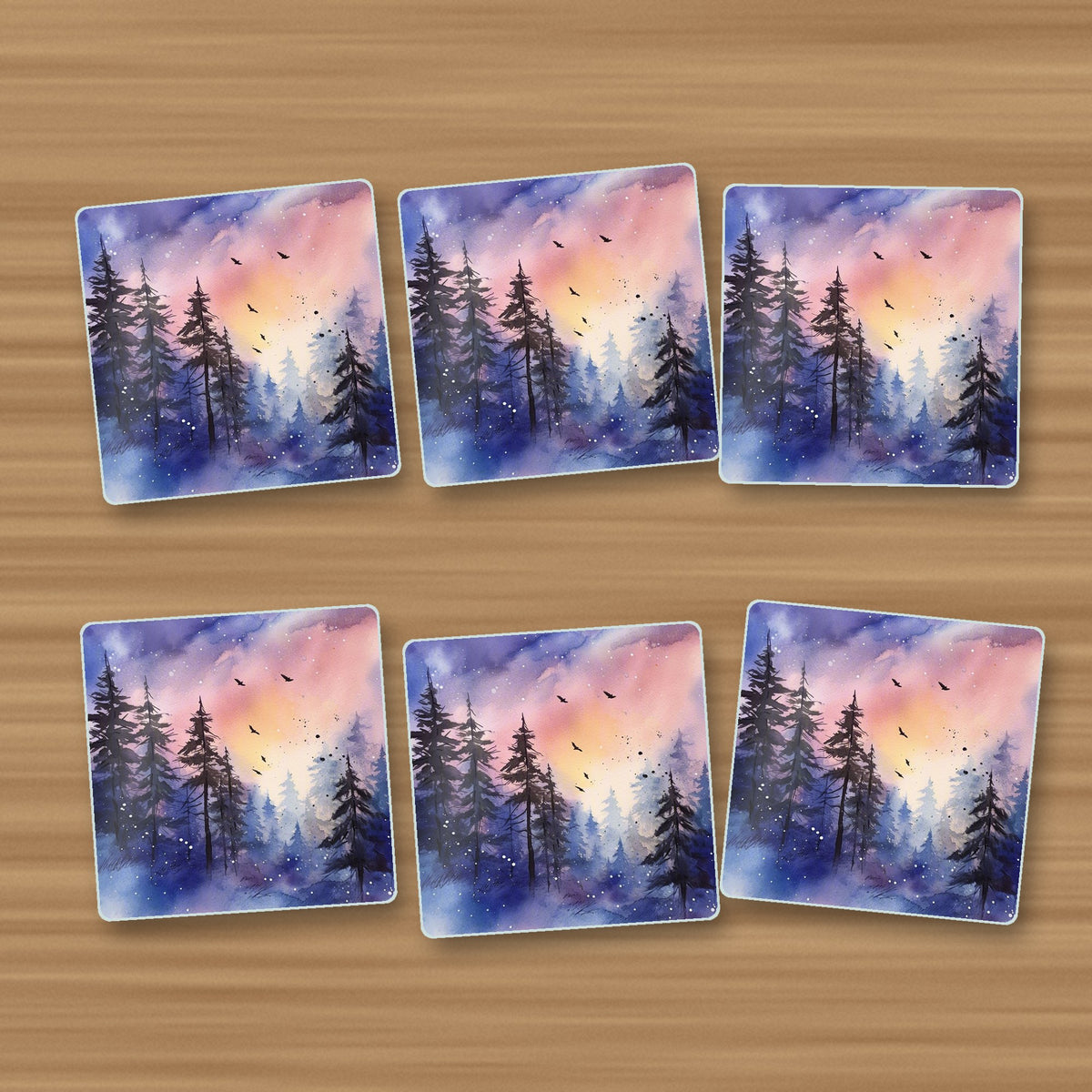 Watercolour Winter Pine Forest square glass coasters, set of 6, on an oak coffee table