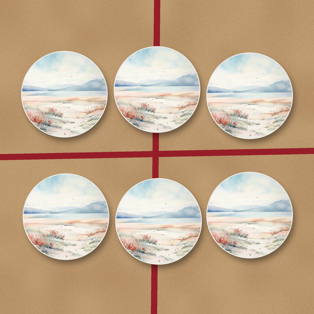 Watercolour Winter Shore round ceramic coasters on kraft gift wrap