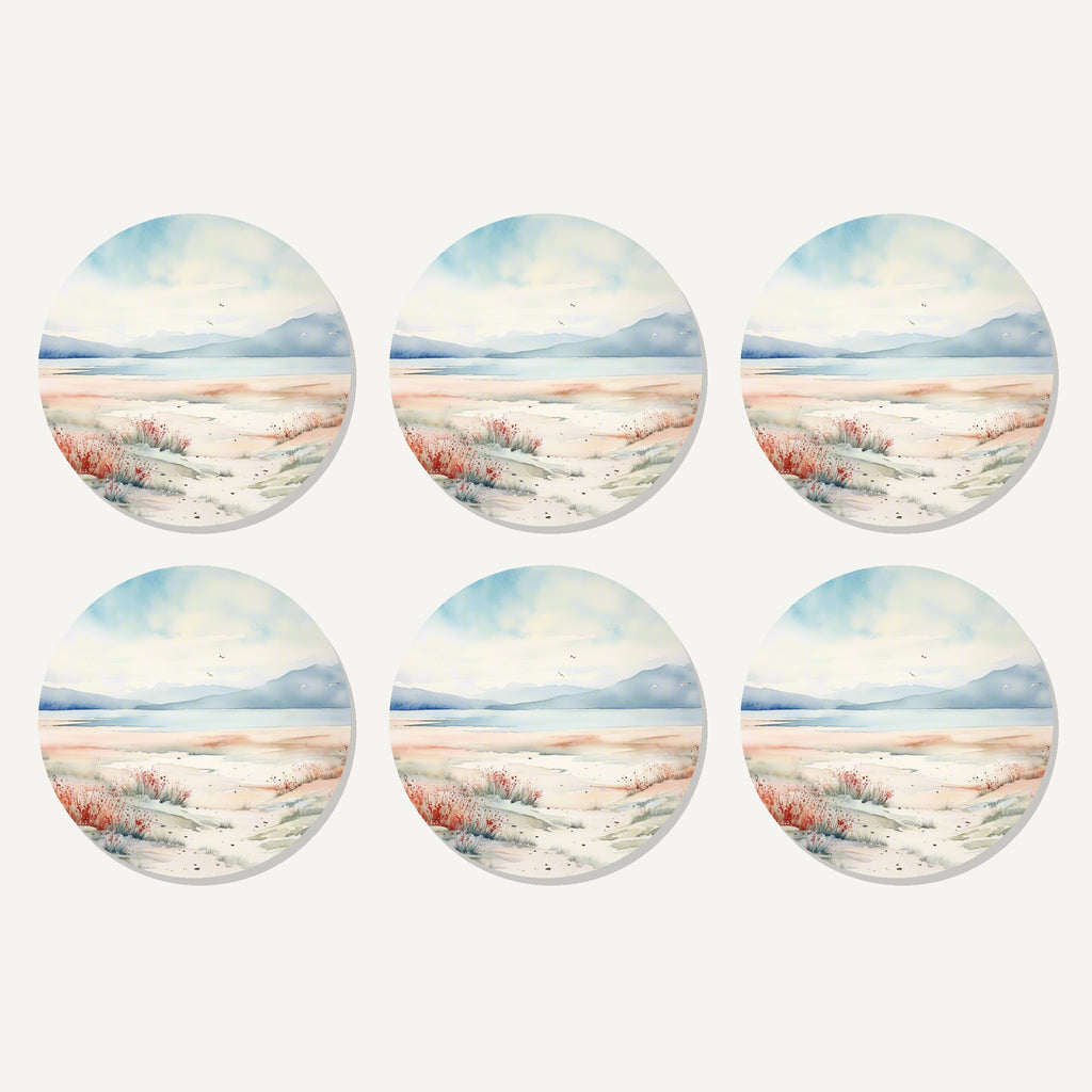 Flat lay of the watercolour winter shore artwork on six round coasters