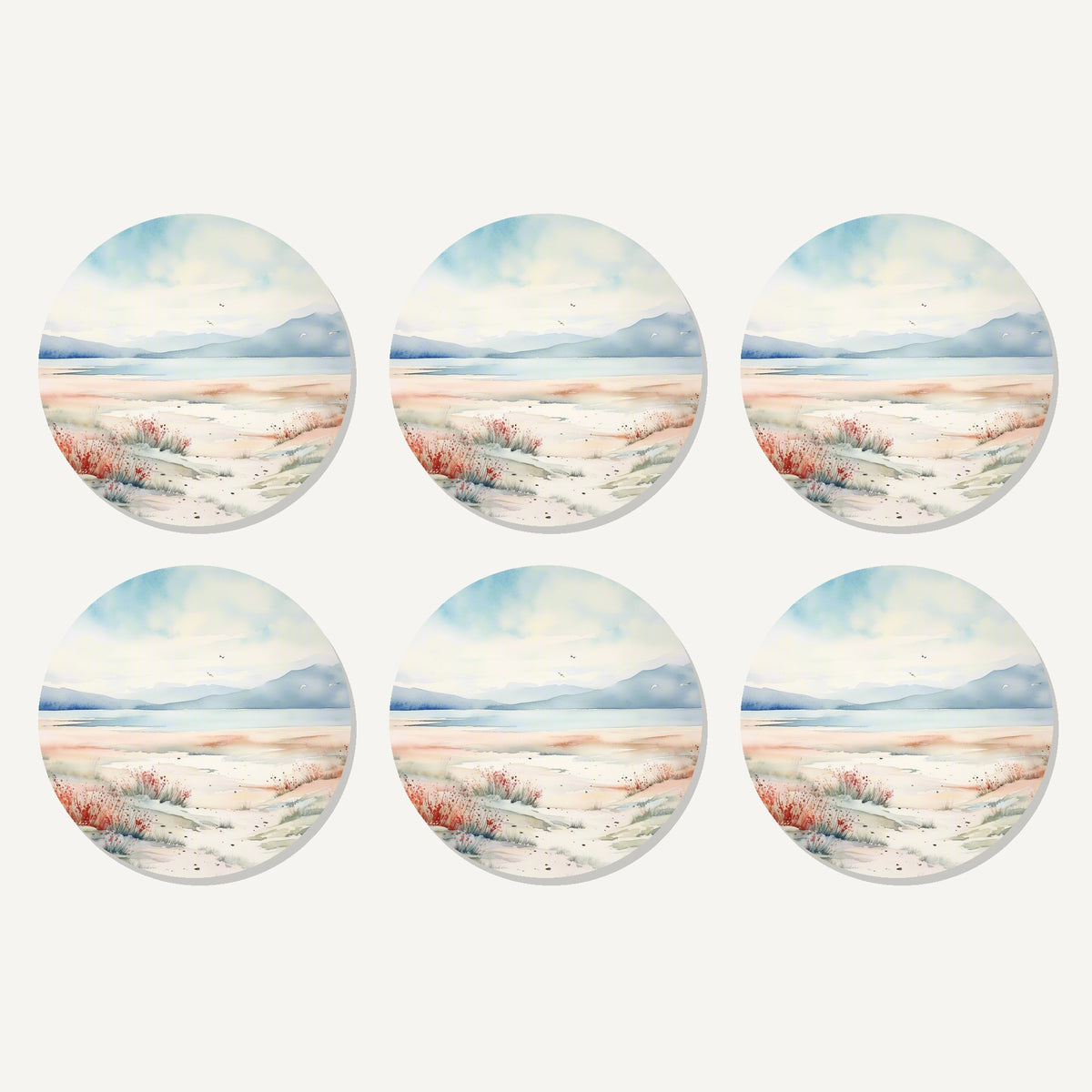 Flat lay of the watercolour winter shore artwork on six round coasters
