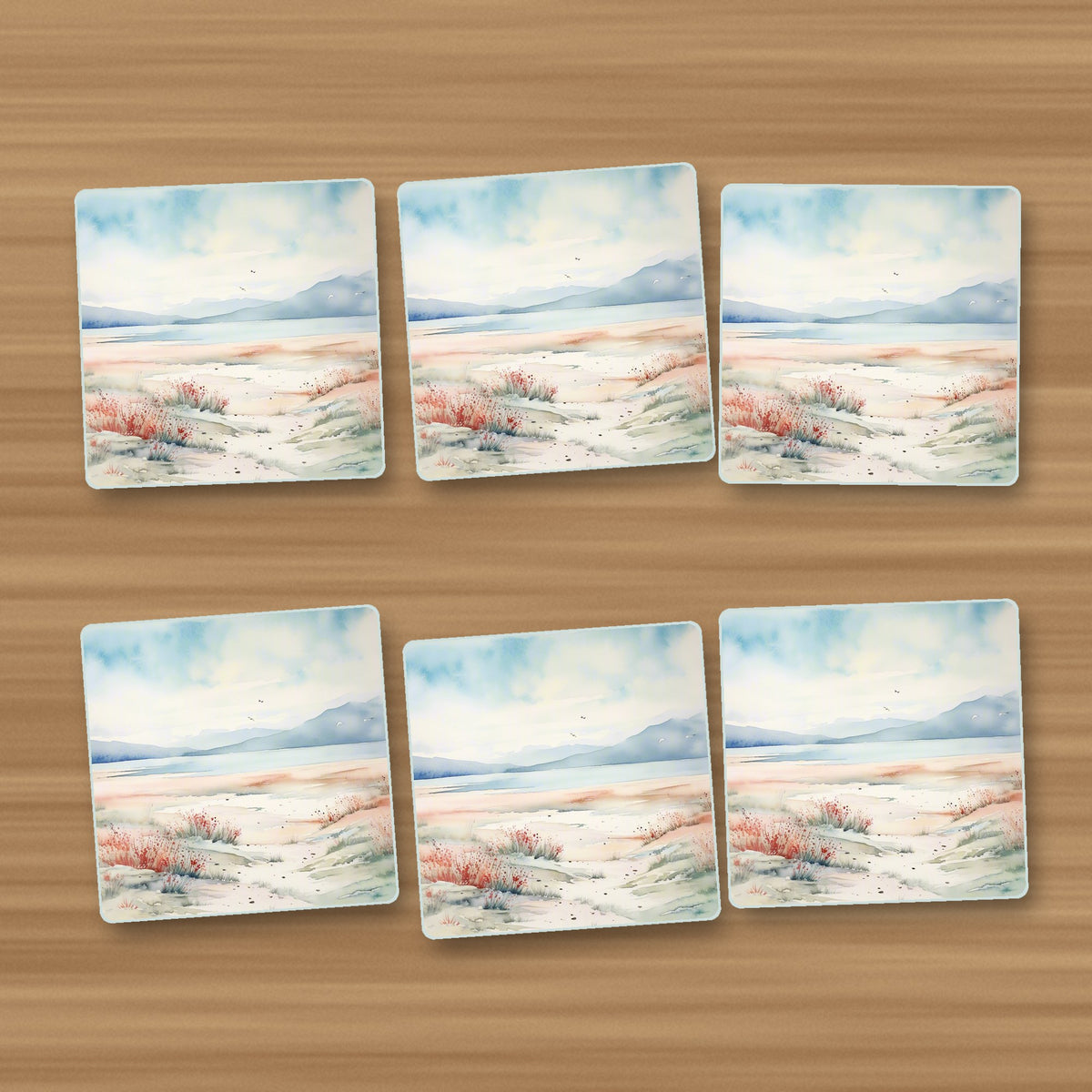 Watercolour Winter Shore square glass coasters, set of 6, on an oak coffee table