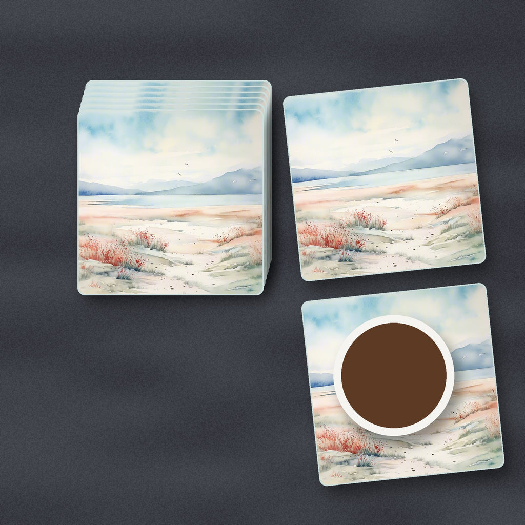 Watercolour Winter Shore square glass coasters stacked on a slate kitchen worktop