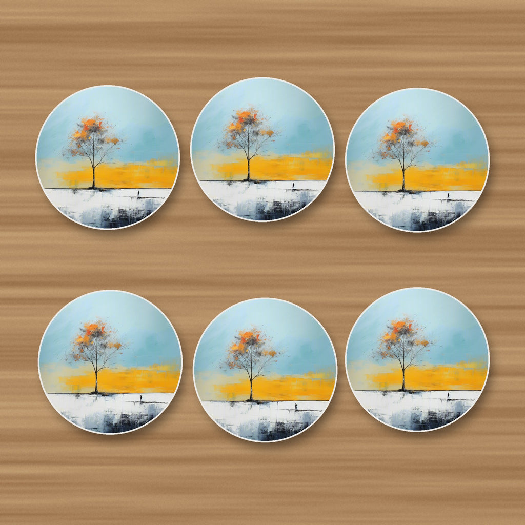 Lone Tree Abstract Landscape round ceramic coasters, set of 6, on an oak coffee table