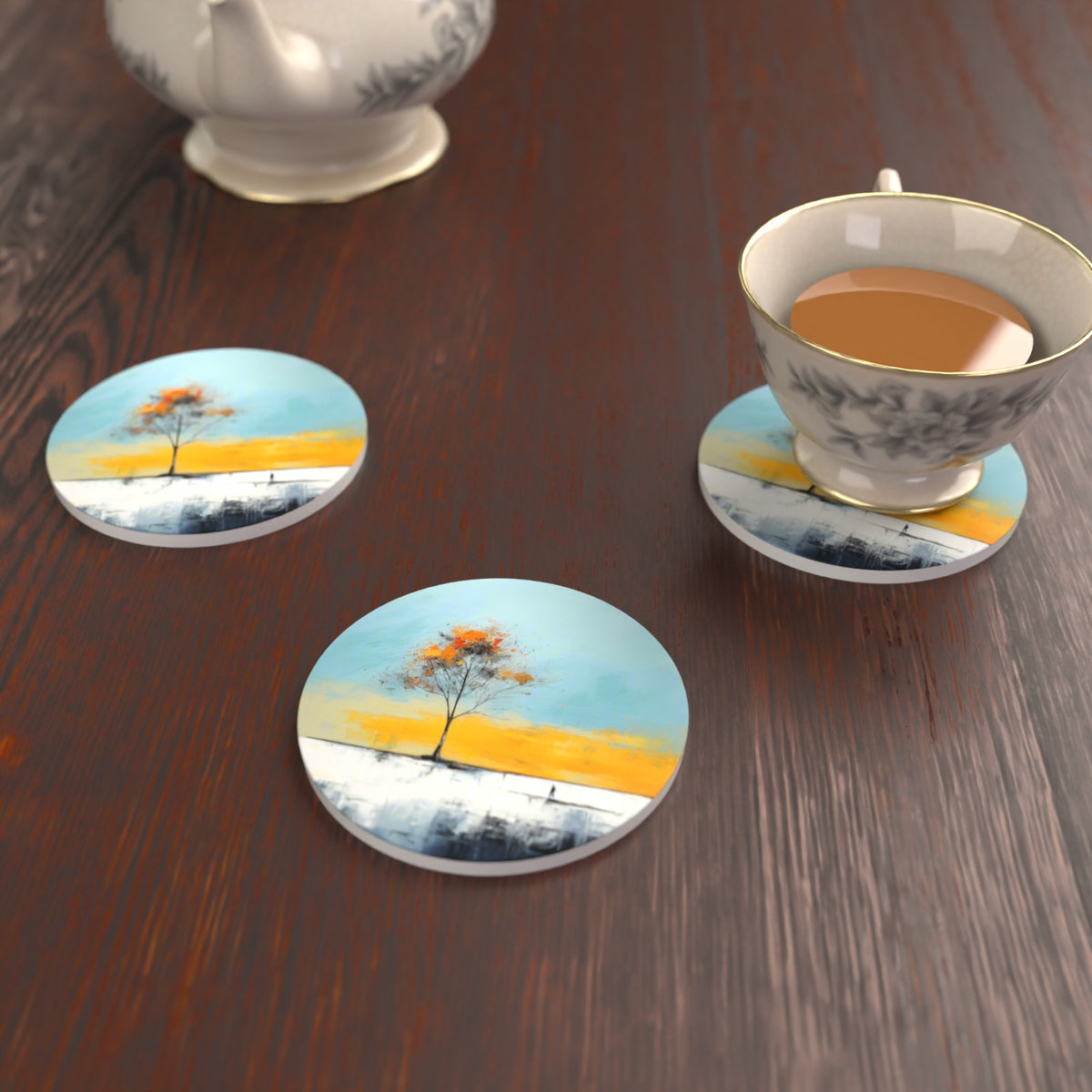Lone Tree Abstract Landscape Round Ceramic Coasters – Set of 6 – lifestyle mockup with a teacup