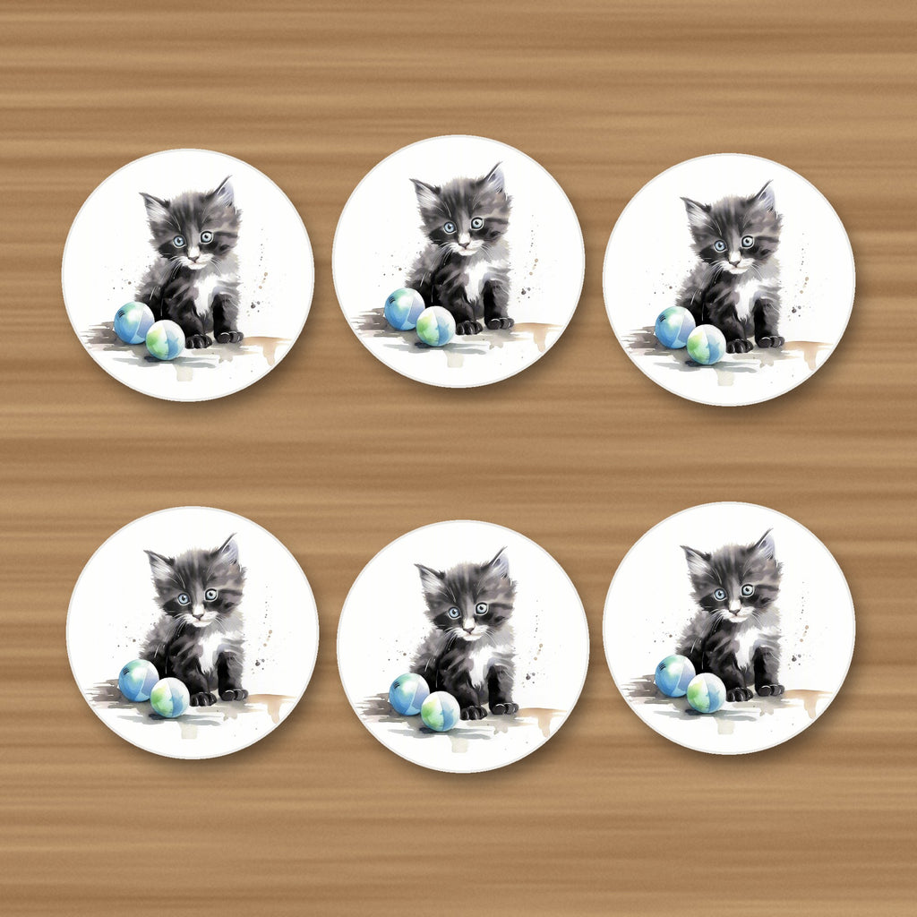 Black & White Kitten with Balls round ceramic coasters, set of 6, on an oak coffee table
