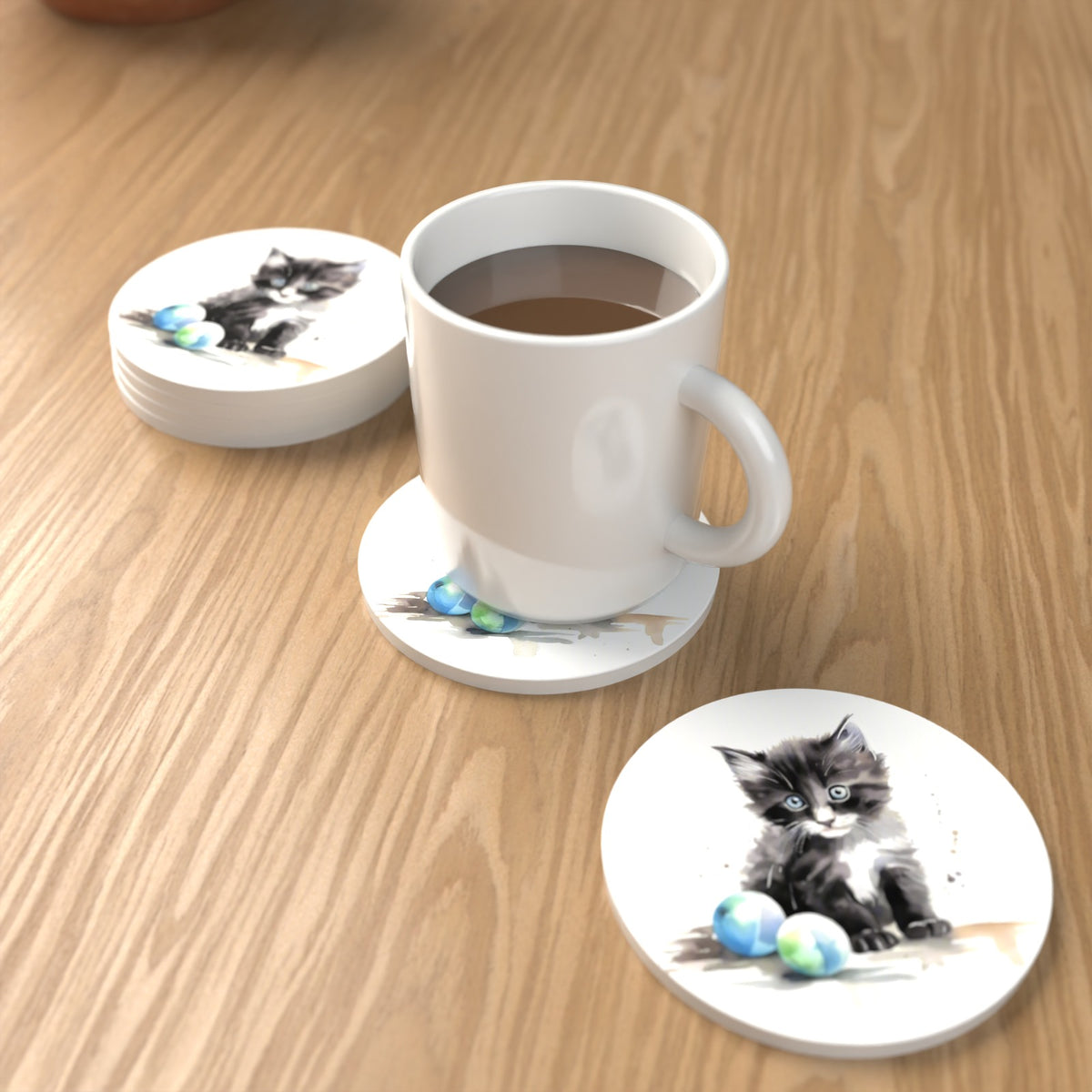 Black & White Kitten with Balls Round Ceramic Coasters – Set of 6 – lifestyle mockup with a mug of coffee