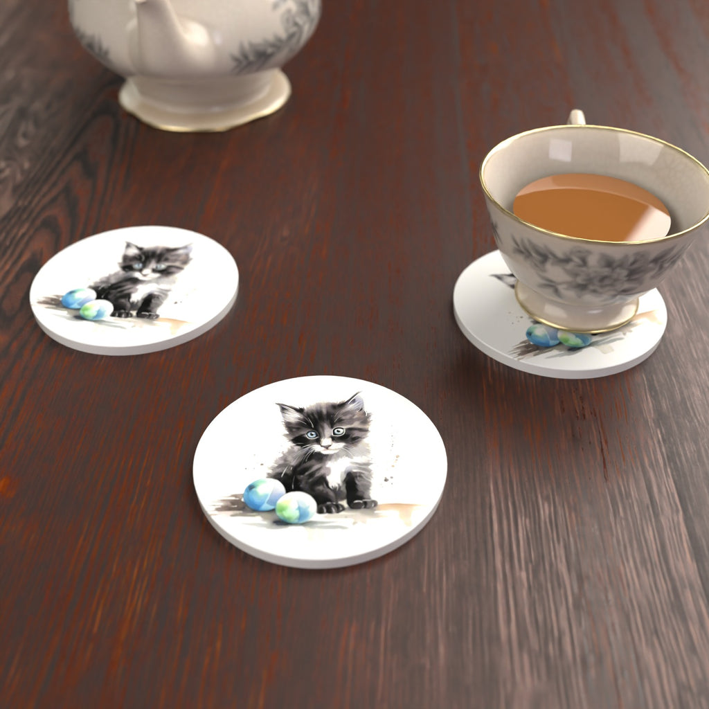 Black & White Kitten with Balls Round Ceramic Coasters – Set of 6 – lifestyle mockup with a teacup