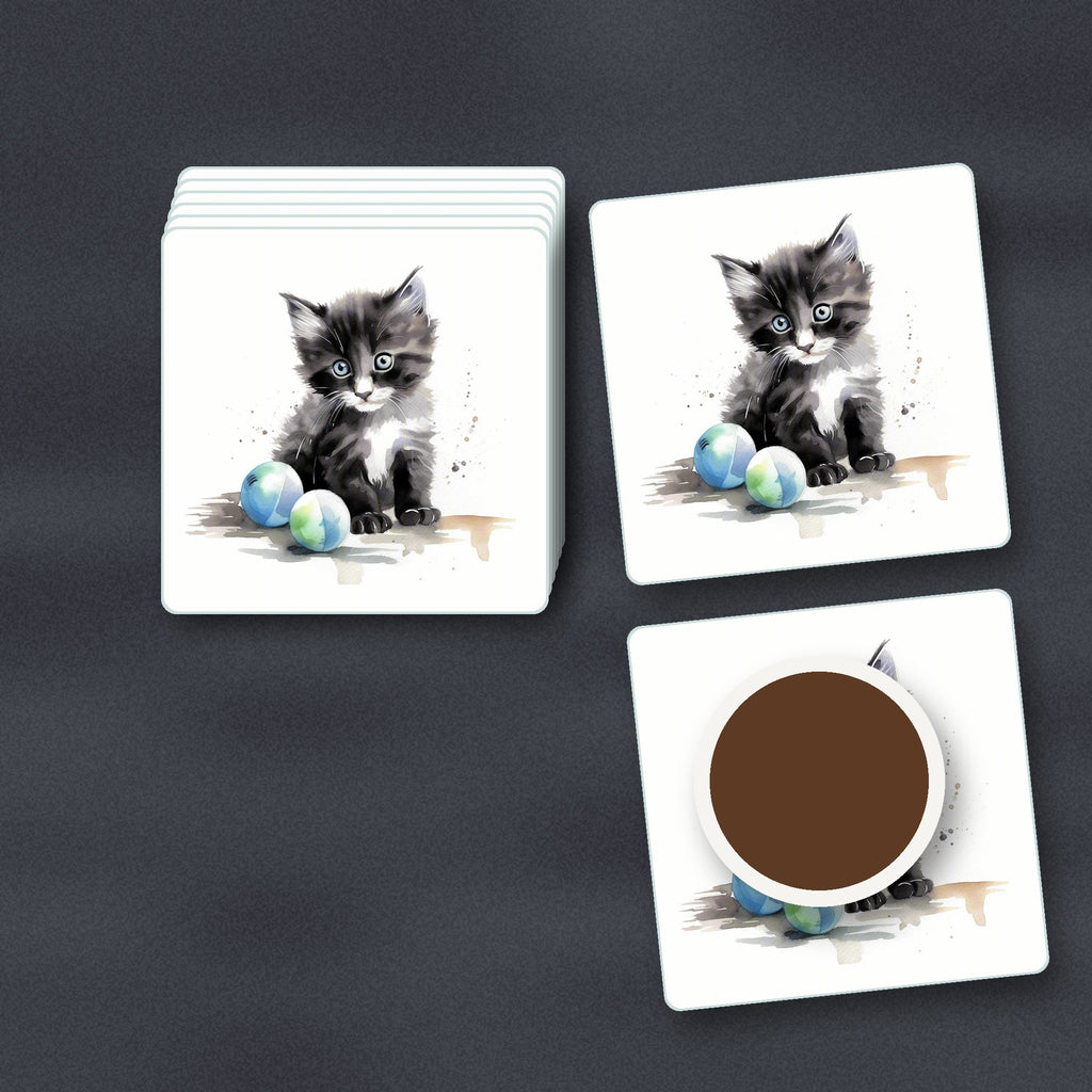 Black & White Kitten with Balls square glass coasters stacked on a slate kitchen worktop