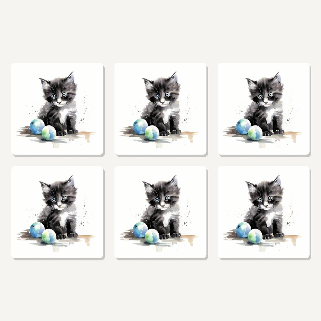 Flat lay of the black & white kitten with balls artwork on six square coasters