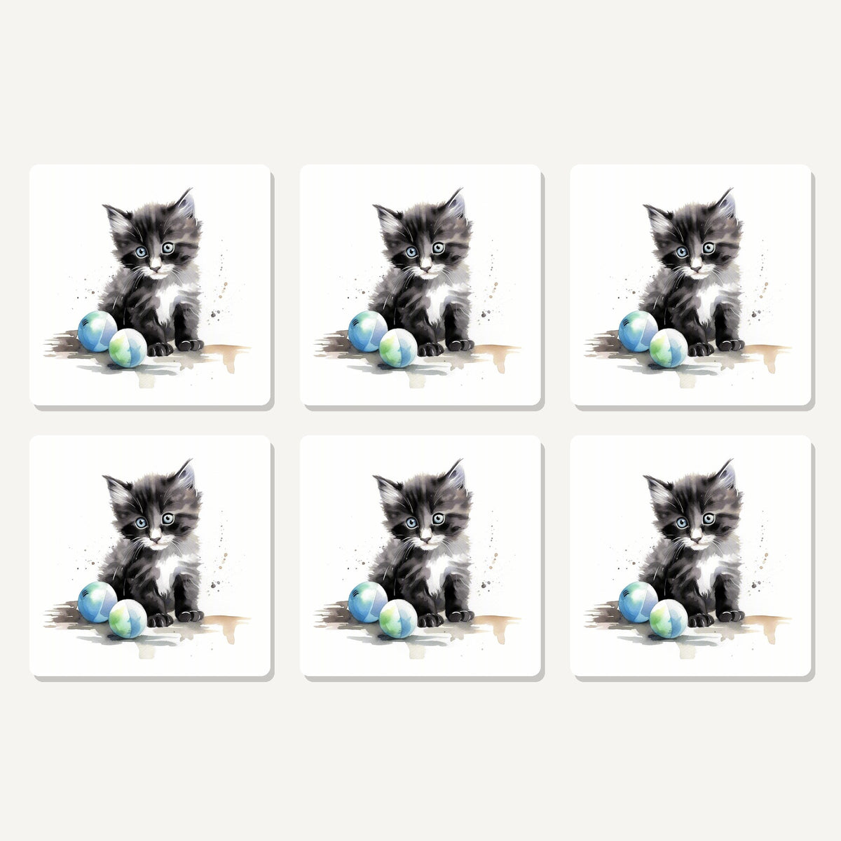 Flat lay of the black & white kitten with balls artwork on six square coasters