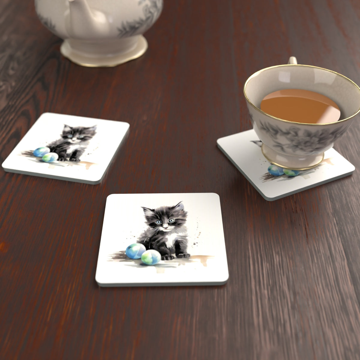 Black & White Kitten with Balls Square Glass Coasters – Set of 6 – lifestyle mockup with a teacup