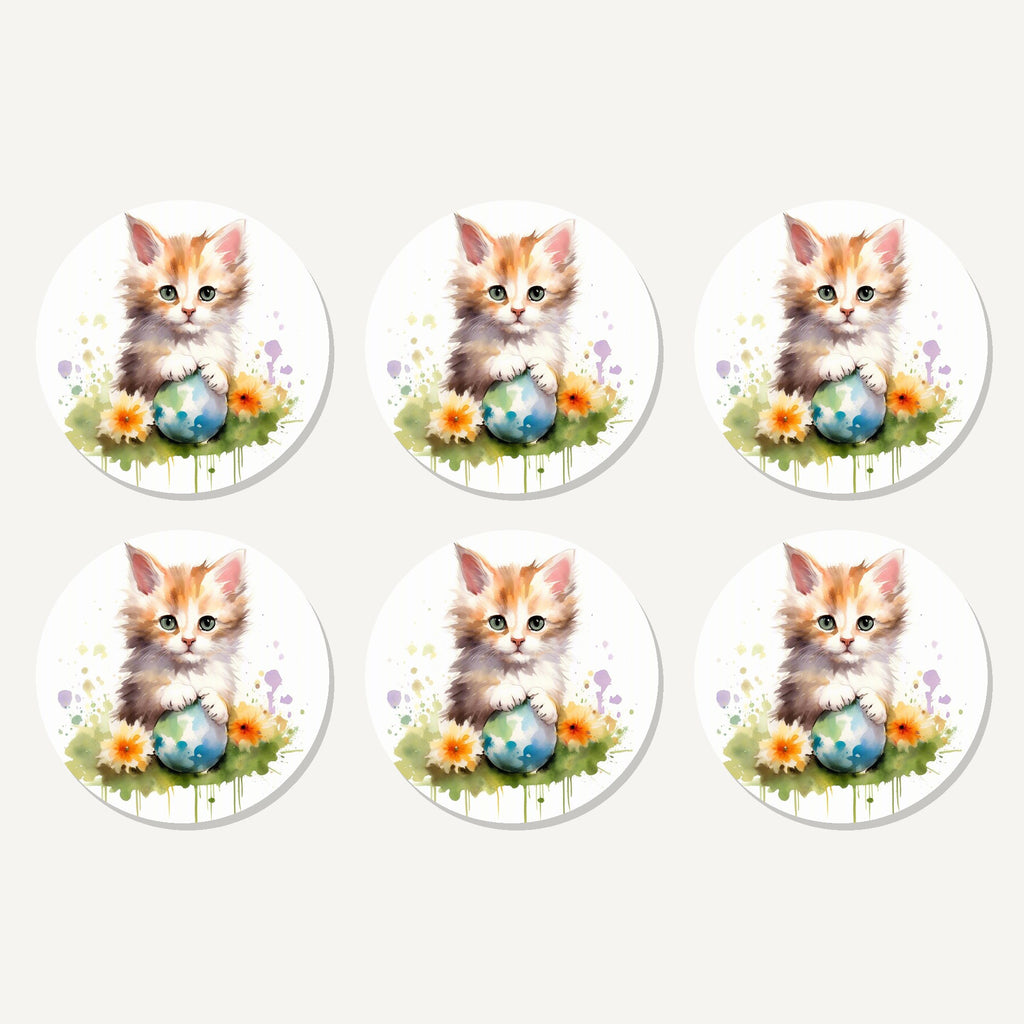 Flat lay of the ginger kitten with flowers & ball artwork on six round coasters