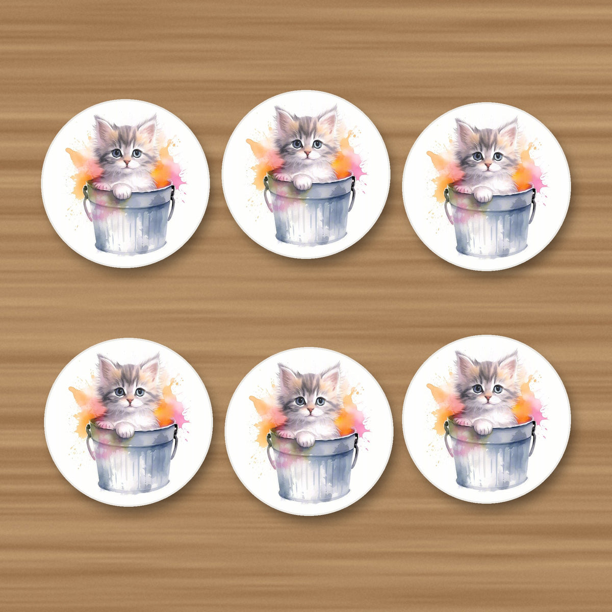 Kitten in a Tin Bucket round ceramic coasters, set of 6, on an oak coffee table