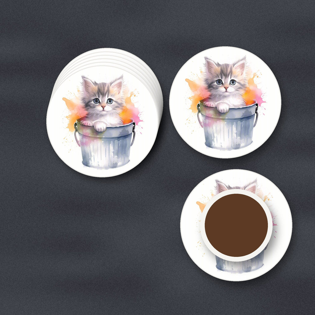 Kitten in a Tin Bucket round ceramic coasters stacked on a slate kitchen worktop