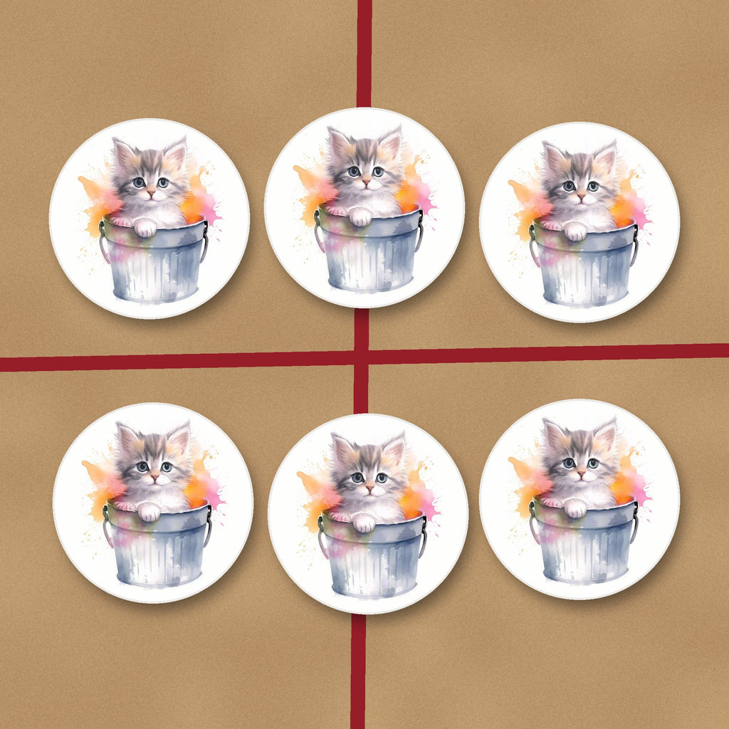 Kitten in a Tin Bucket round ceramic coasters on kraft gift wrap