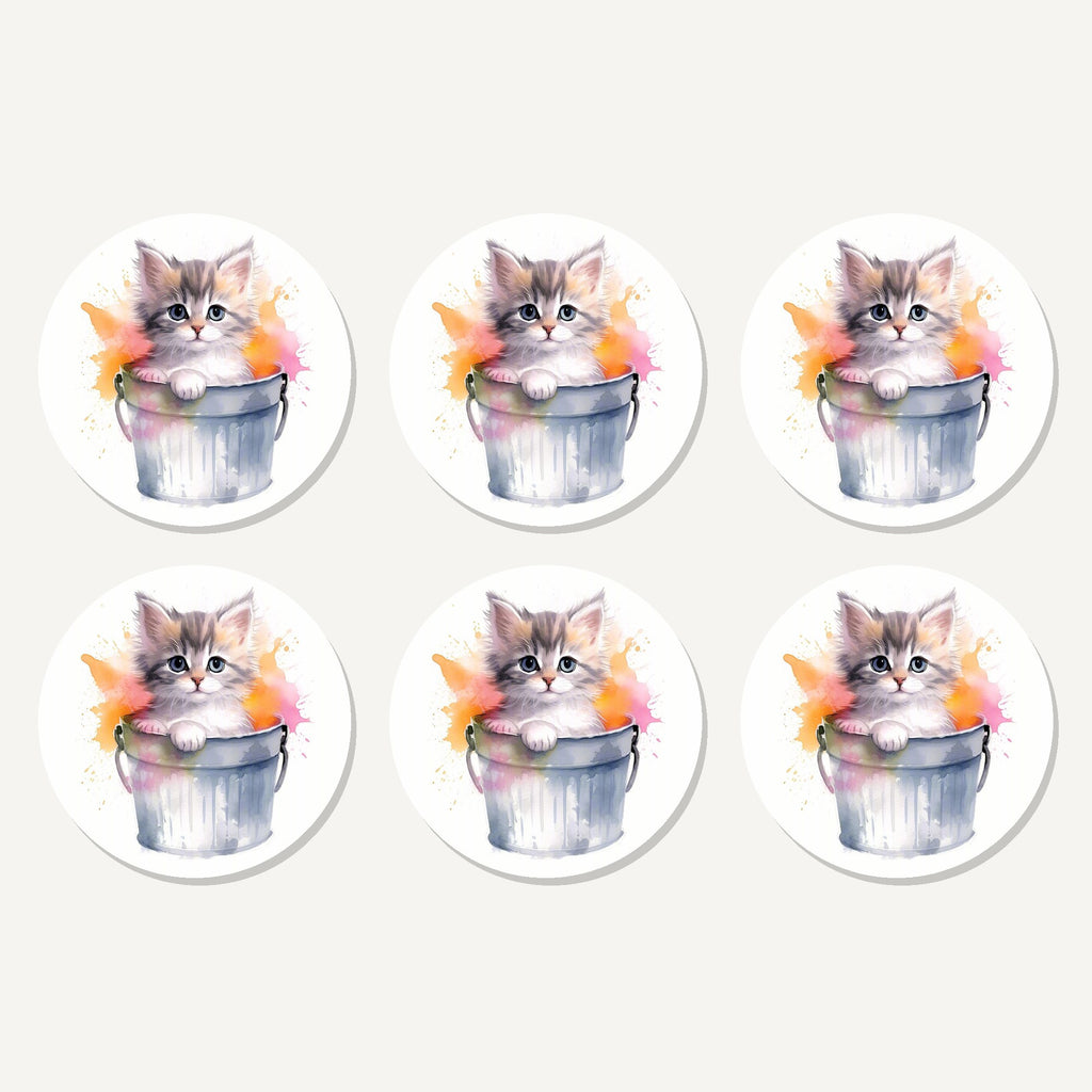 Flat lay of the kitten in a tin bucket artwork on six round coasters