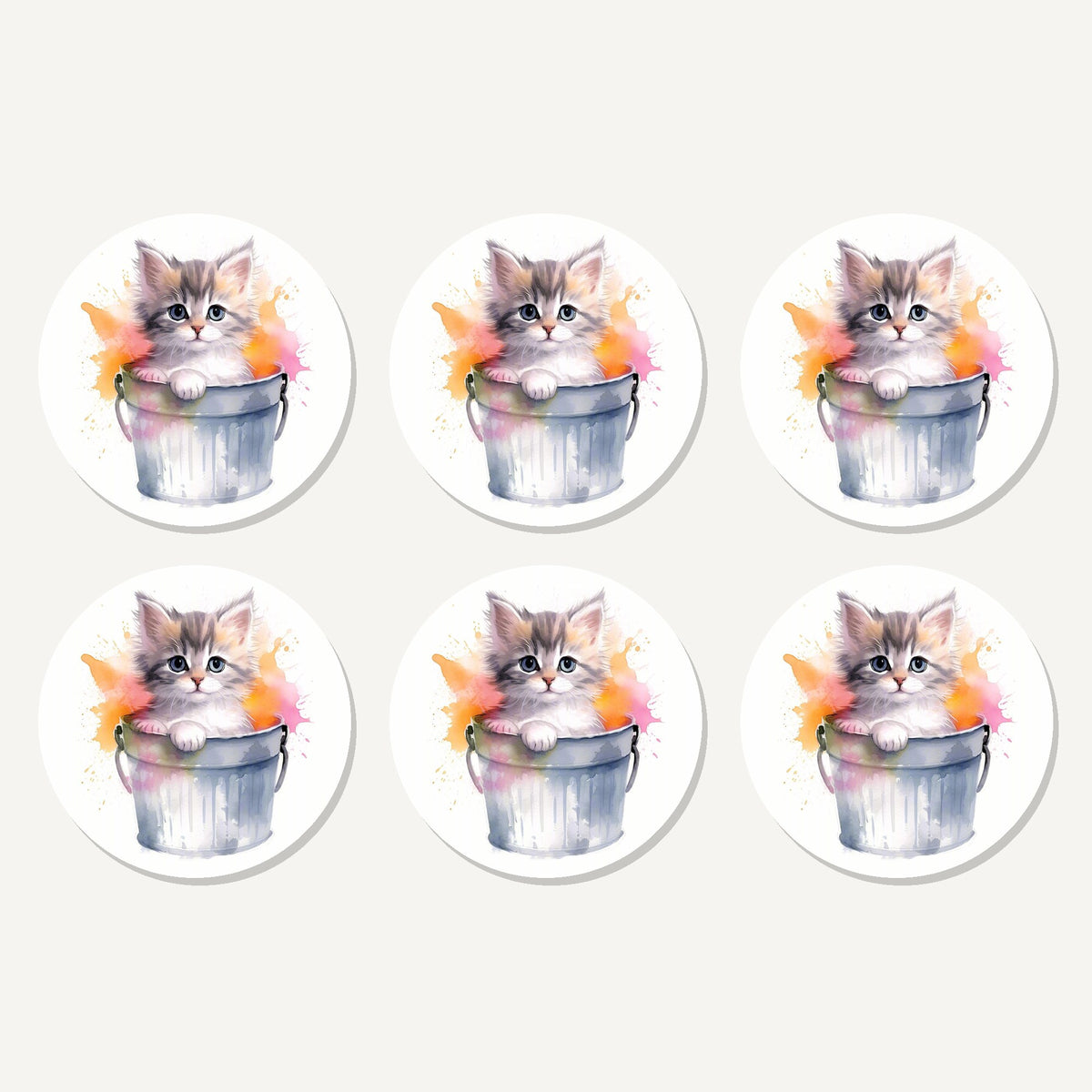 Flat lay of the kitten in a tin bucket artwork on six round coasters