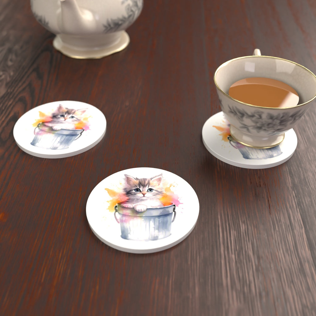 Kitten in a Tin Bucket Round Ceramic Coasters – Set of 6 – lifestyle mockup with a teacup