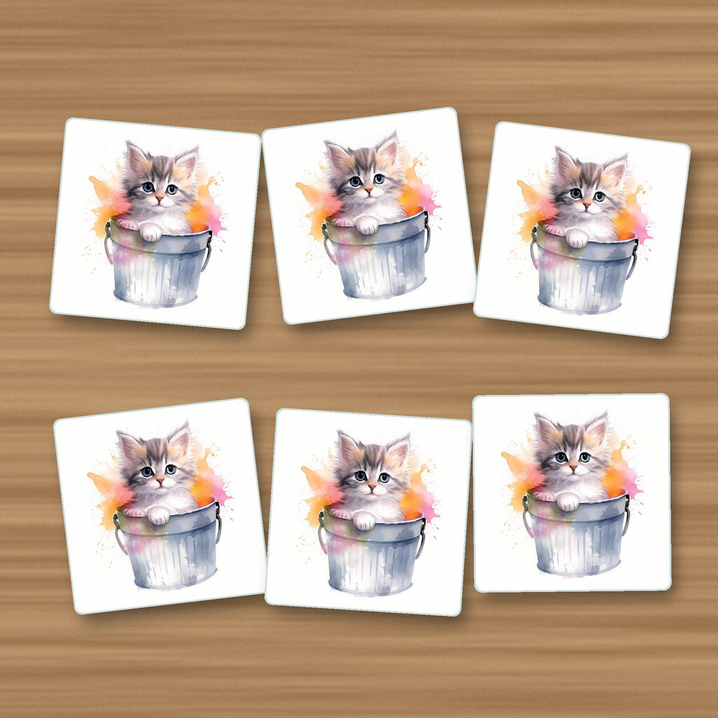 Kitten in a Tin Bucket square glass coasters, set of 6, on an oak coffee table