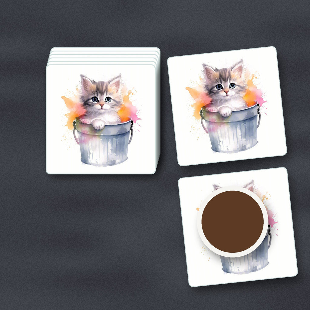 Kitten in a Tin Bucket square glass coasters stacked on a slate kitchen worktop