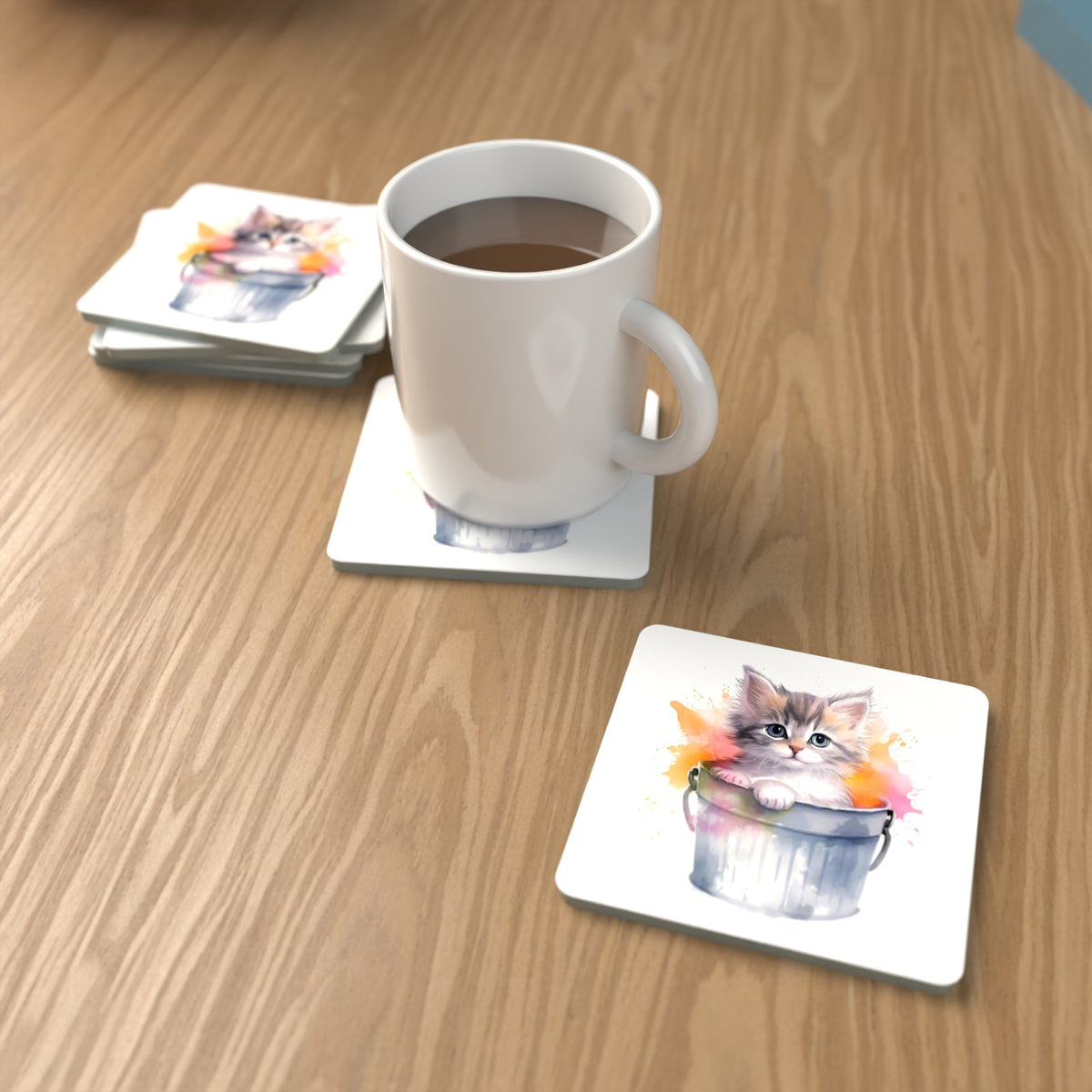 Kitten in a Tin Bucket Square Glass Coasters – Set of 6 – lifestyle mockup with a mug of coffee