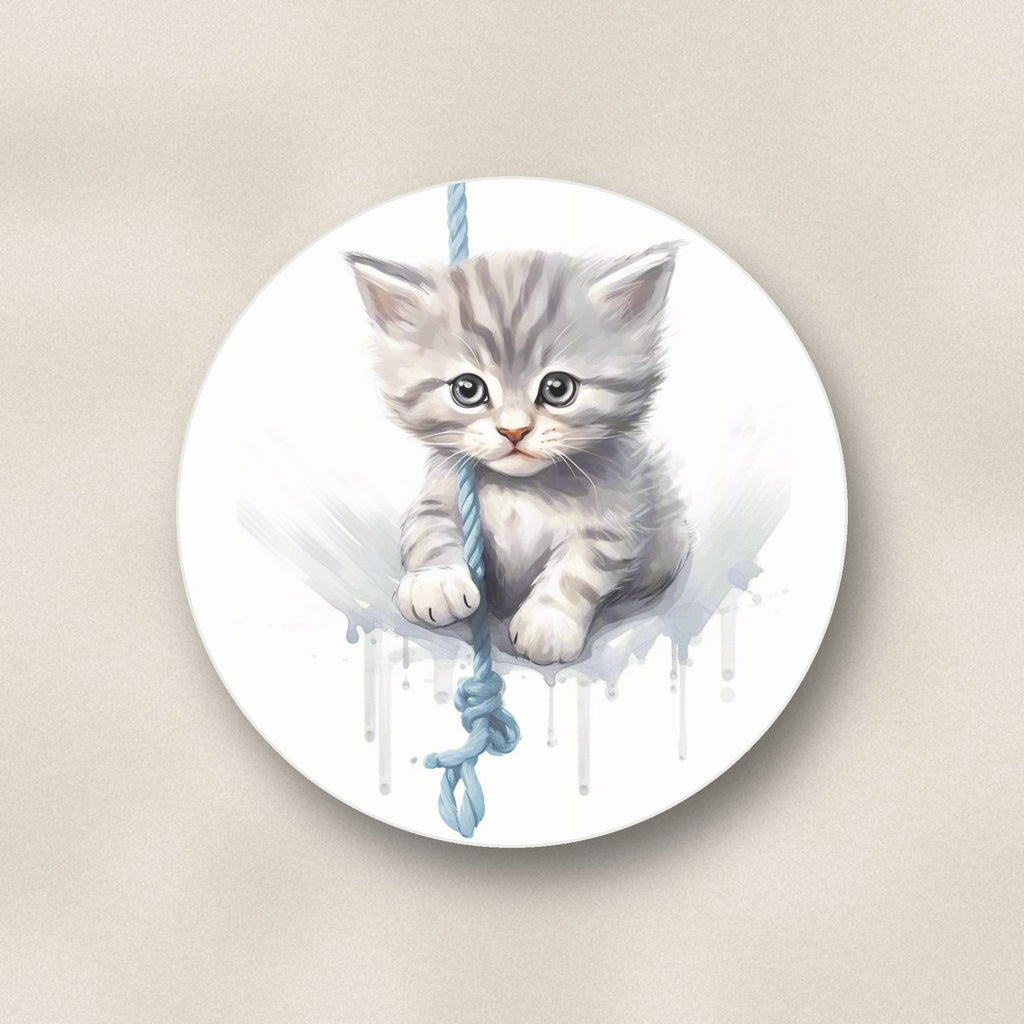 Close-up of one grey tabby kitten on a rope round ceramic coaster, flat UV print