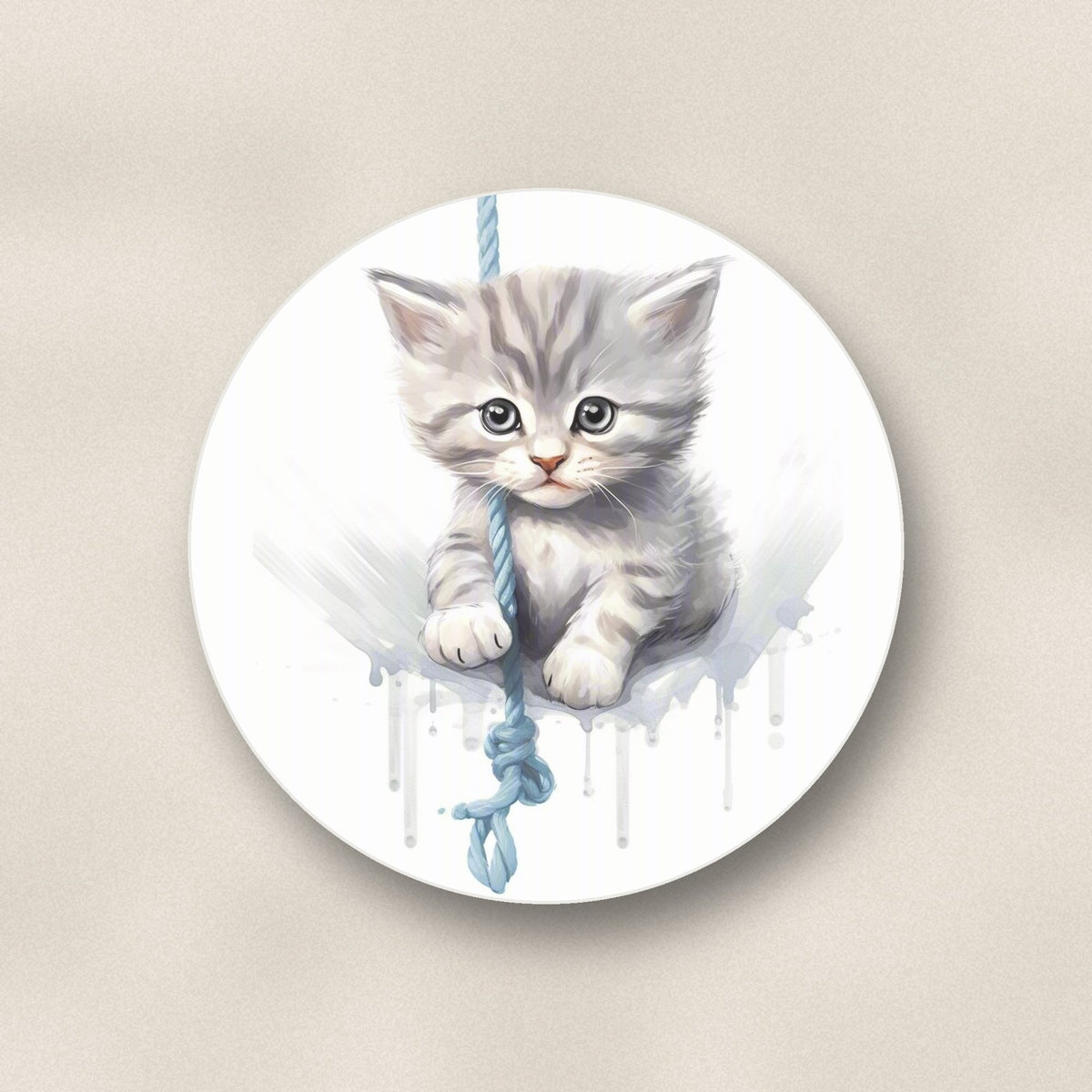 Close-up of one grey tabby kitten on a rope round ceramic coaster, flat UV print