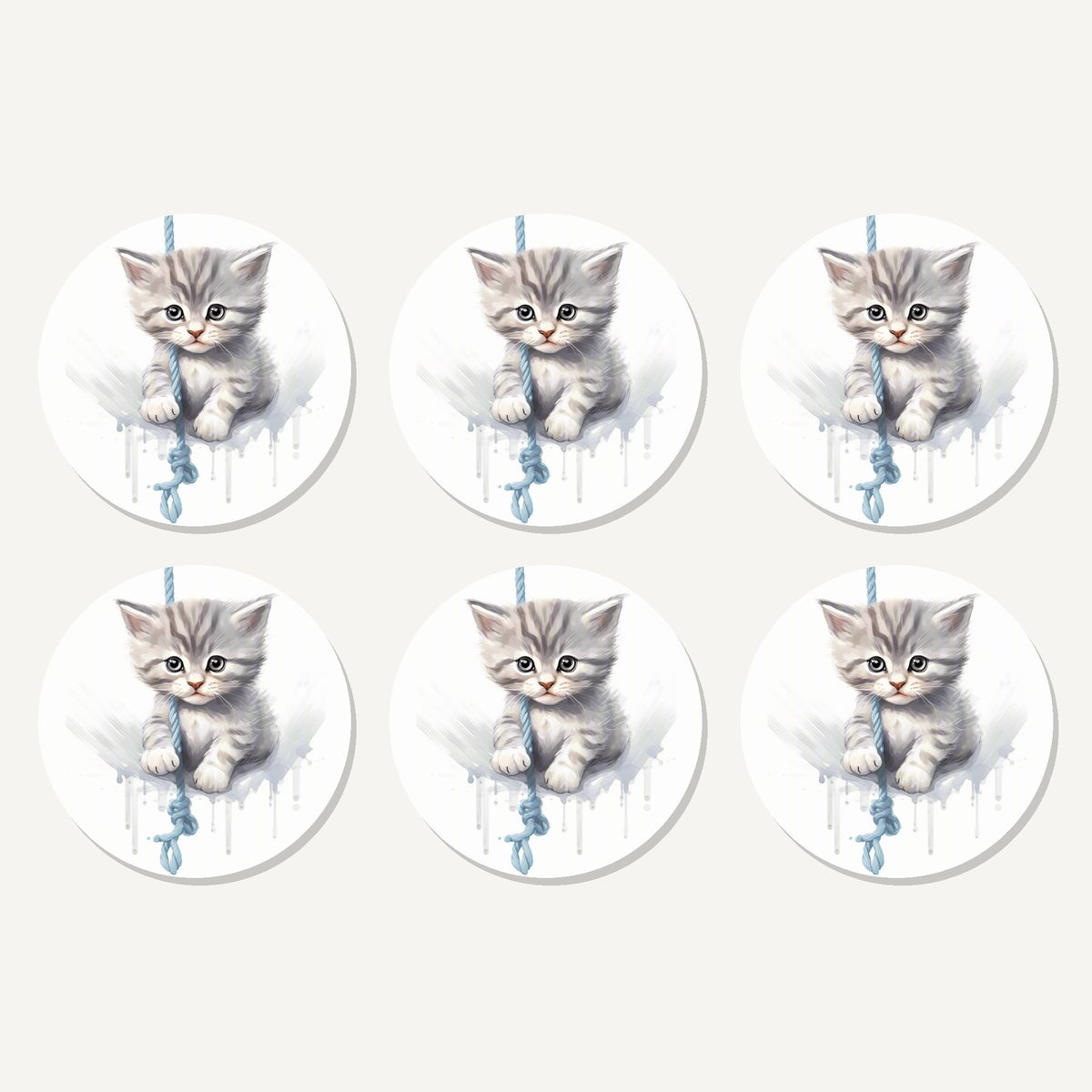 Flat lay of the grey tabby kitten on a rope artwork on six round coasters