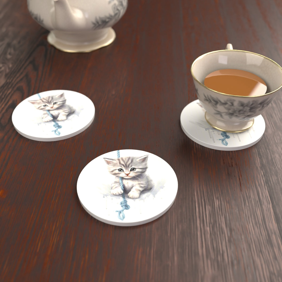 Grey Tabby Kitten on a Rope Round Ceramic Coasters – Set of 6 – lifestyle mockup with a teacup