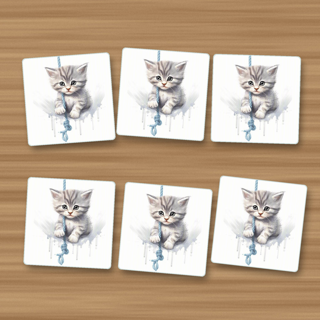 Grey Tabby Kitten on a Rope square glass coasters, set of 6, on an oak coffee table