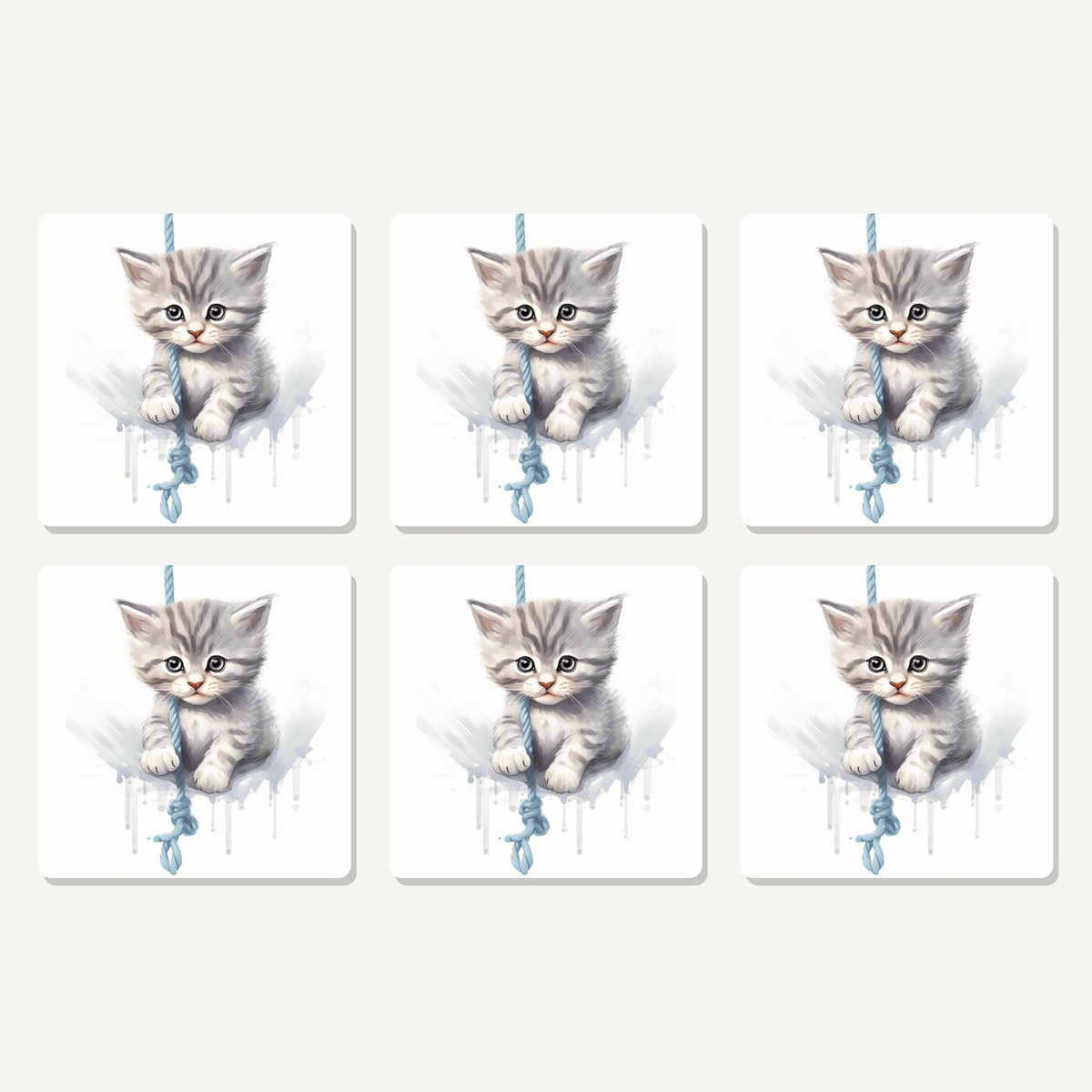 Flat lay of the grey tabby kitten on a rope artwork on six square coasters
